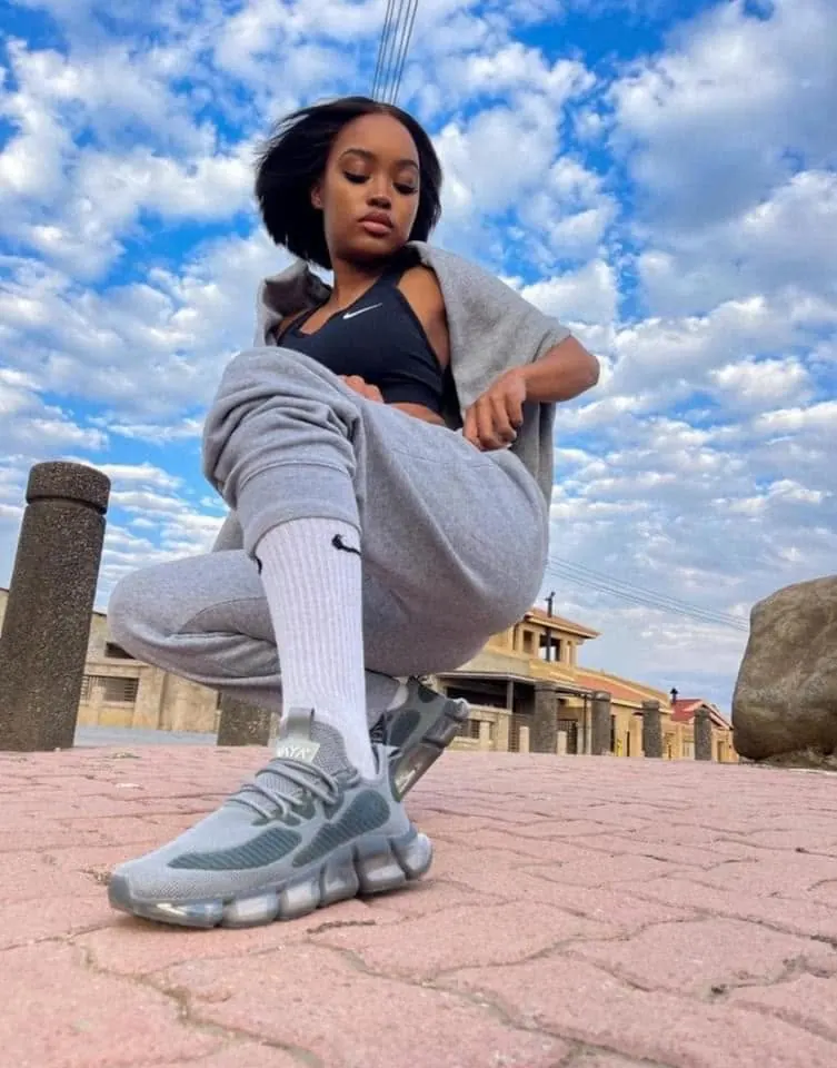 VAYA Sky Blue sneakers worn with a grey tracksuit outdoors
