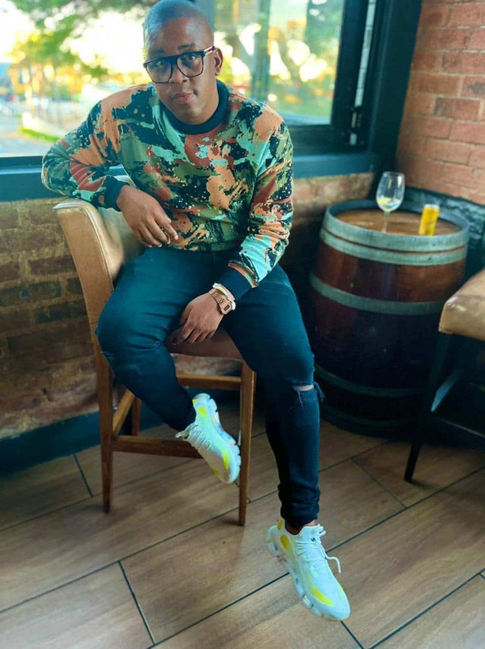 VAYA Sky Blue sneakers worn with a colourful shirt